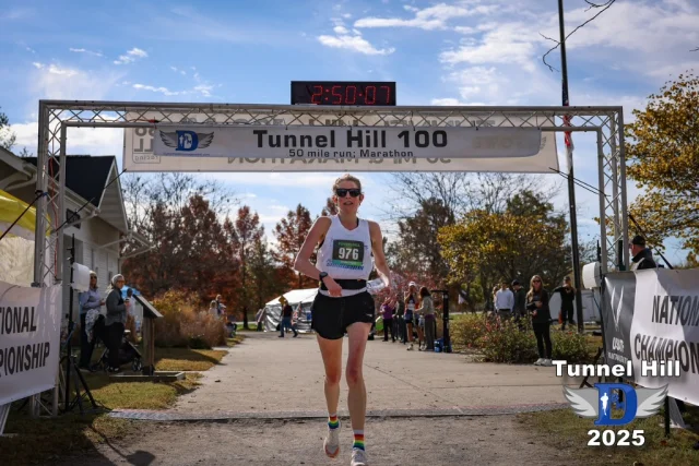 Allison Mercer crossing the Tunnel Hill marathon finish line in 2025