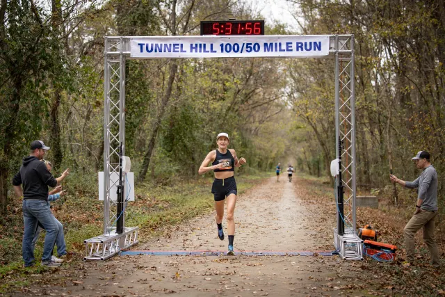 Courtney Olsen crossing the Tunnel Hill finish line