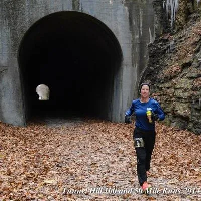 Traci Falbo running beside the Tunnel Hill tunnel during the inaugural race